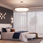 Luxurious and Modern Bedroom with an Ornate Chandelier, a Tufted Headboard, and a Dark Accent Wall with Decorative Mirrors